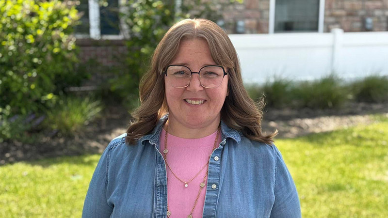 Smiling Traditions of Grove City employee standing outdoors