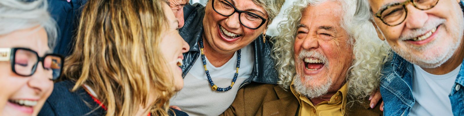 A group of older men and women laughing together.