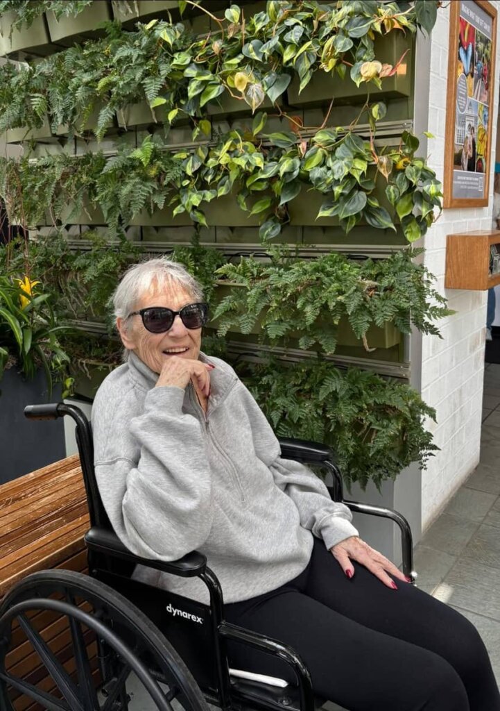 Smiling resident enjoying a visit to Franklin Park Conservatory during a Grove City Senior Living outing